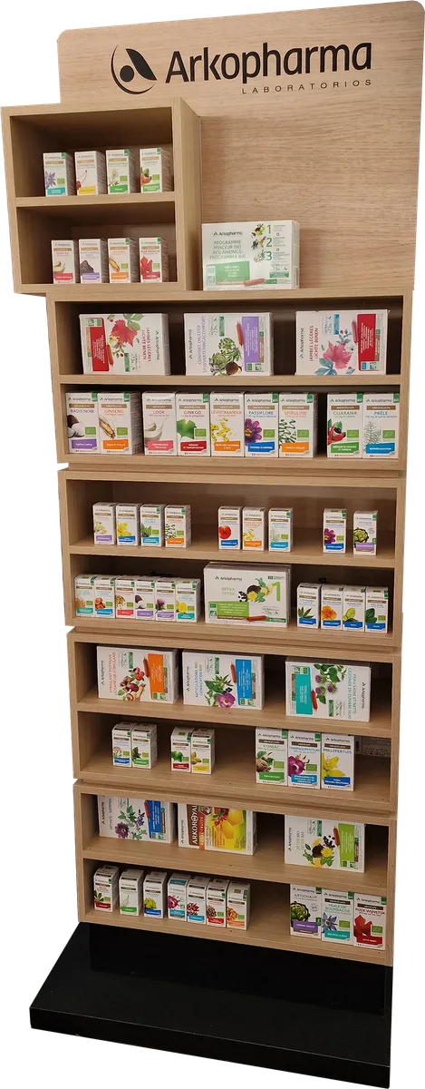Arkopharma floor unit in a light wood finish with a branded header, an upper block of cubbies and seven shelves full of plant-based packs, on a black plinth