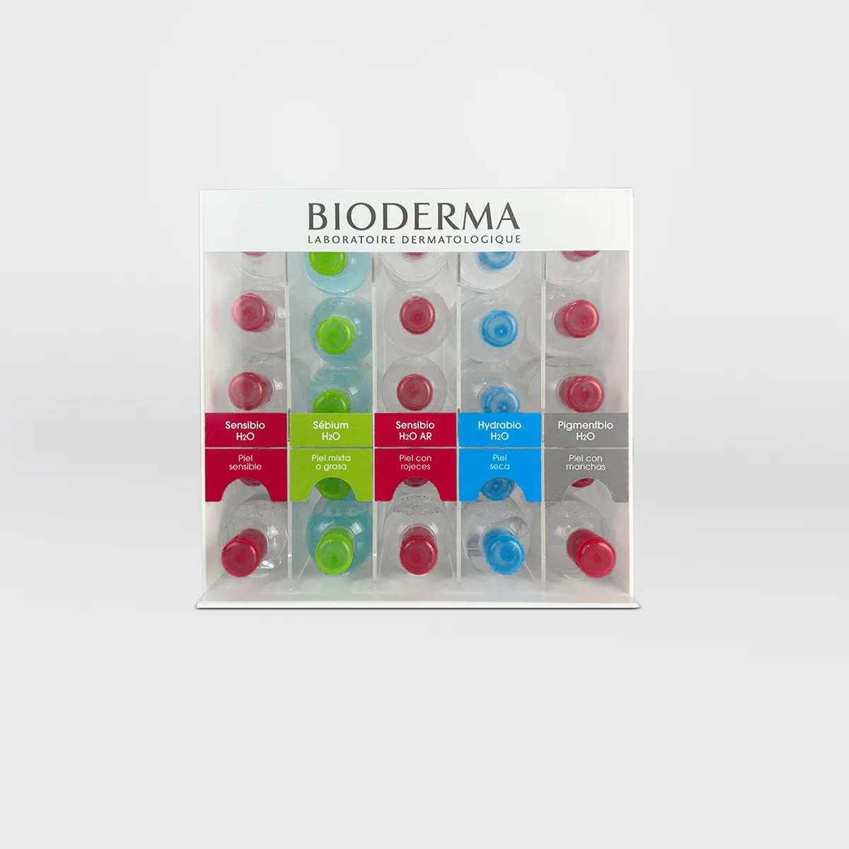 Bioderma counter dispenser with five columns of micellar water bottles lying down, the coloured cap of each range in view and a strip of labels by skin type